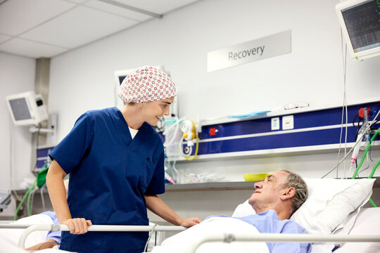 Doctor Interacts With Patient in Hospital Recovery Room