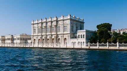 Fototapeta premium Dolmabahce palace facade showcasing ottoman architecture along the bosphorus strait, reflecting turkish history and culture on a clear day in istanbul