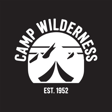 Camp Wilderness logo established 1952 with tent and mountains under sun graphic design