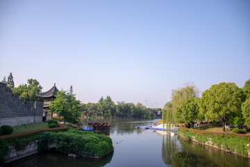 Obraz premium Traditional Chinese Pavilion by a Calm River in a Scenic Park