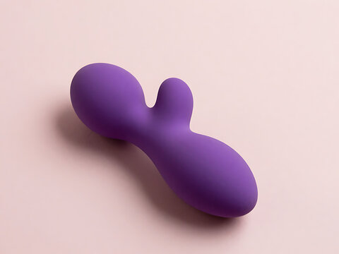 Purple double ended butt plug on pink background for adult use