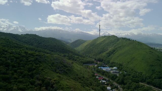 6.6.2026 Almaty.Kazakhstan. Aerial view of Kok Tobe hill with Almaty television tower and snowy mountains background, Kazakhstan