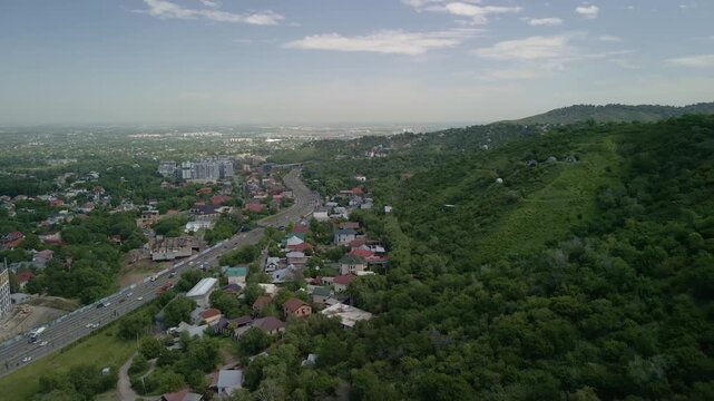 Aerial view of Almaty city skyline and highway traffic from Kok Tobe hill, Kazakhstan