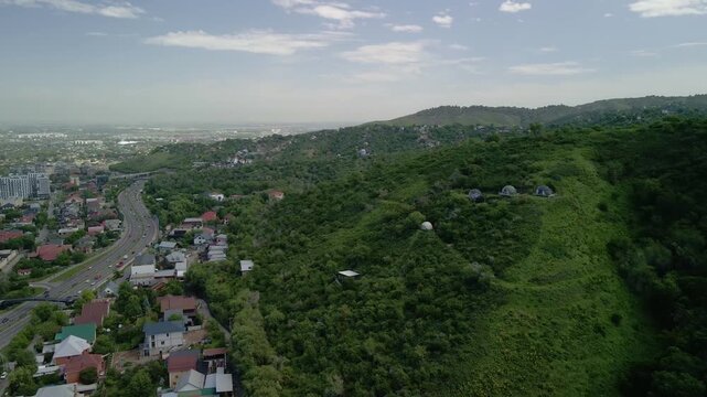 Aerial view of Almaty city skyline and highway traffic from Kok Tobe hill, Kazakhstan
