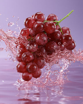 red grapes splashing in water