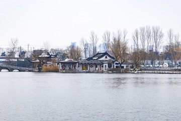 Fototapeta premium Winter view of traditional Chinese garden pavilions by a lakeside