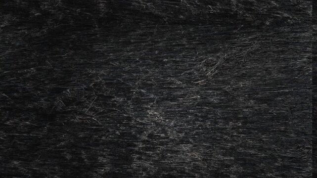 Dark textured surface with subtle scratches, vertical shading, and delicate metallic-looking streaks throughout. Grunge texture background animation.
