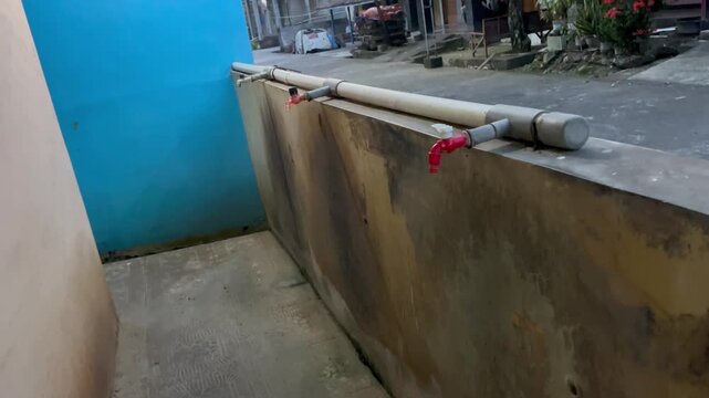 Outdoor water tap faucet with PVC pipe plumbing installation