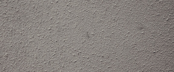 Fototapeta premium Rough gray stucco wall texture suitable for backgrounds in industrial designs, construction concepts, or urbanthemed projects with a gritty aesthetic.