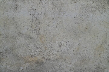Gray rough textured cement stone surface wall for background design, industrial themes, construction websites, and gritty textures in design projects. © Dinamartina93