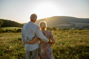 Fototapeta premium Senior couple on walk during sunset.