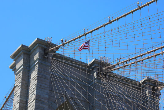 American flag waving on the Brooklyn Bridge tower