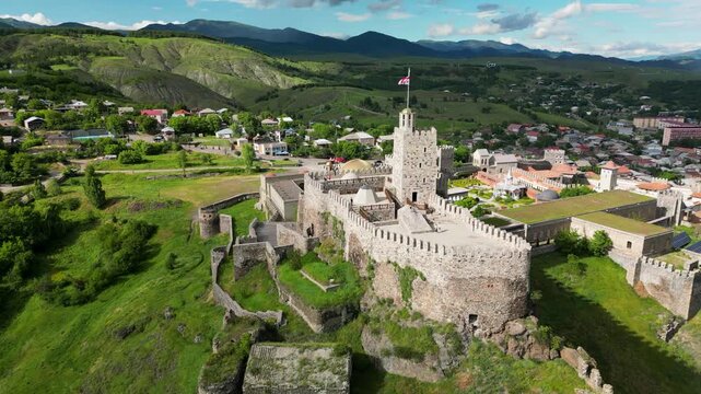 Aerial drone view of Rabati Castle in Akhaltsikhe, a historic fortress complex in southern Georgia featuring medieval architecture, defensive walls, towers and landscaped grounds.