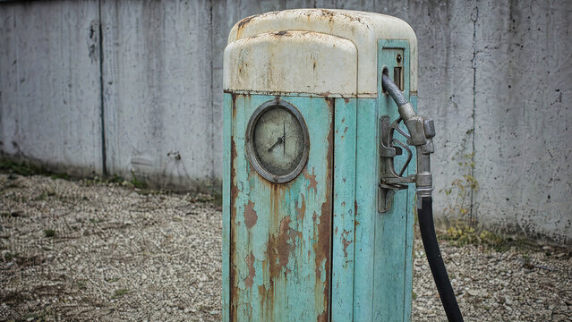 Rusted vintage fuel pump with peeling turquoise paint