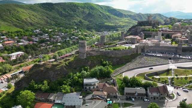 Aerial drone view of Rabati Castle in Akhaltsikhe, a historic fortress complex in southern Georgia featuring medieval architecture, defensive walls, towers and landscaped grounds.