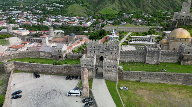 Aerial drone view of Rabati Castle in Akhaltsikhe, a historic fortress complex in southern Georgia featuring medieval architecture, defensive walls, towers and landscaped grounds.