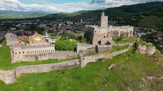 Aerial drone view of Rabati Castle in Akhaltsikhe, a historic fortress complex in southern Georgia featuring medieval architecture, defensive walls, towers and landscaped grounds.