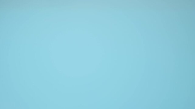 Man receiving vitamin capsules from bottle into hand on blue background in close-up. Vitamins support daily nutrition goals, dietary balance and wellness routines for healthy lifestyle concepts