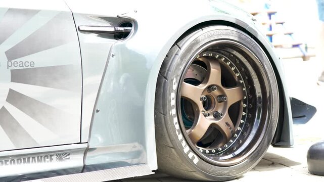 Closeup of a large alloy wheel and low profile tire on a tuned sports car
