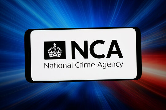Stuttgart, Germany - 06-10-2026: In this photo illustration, the logo of United Kingdom National Crime Agency (NCA) is displayed on a smartphone in front of abstract background on computer screen.