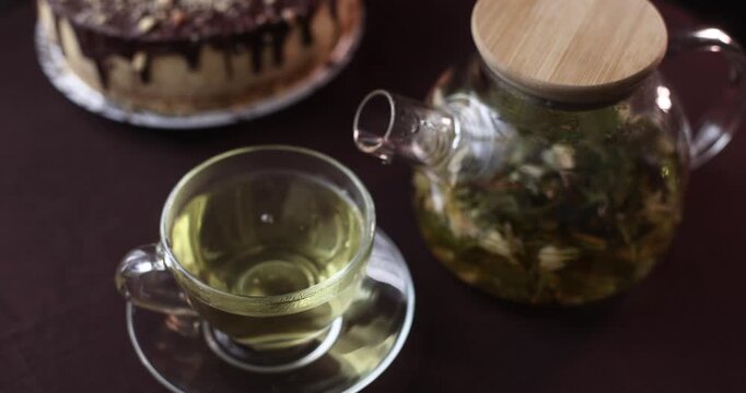aromatic, fruity green tea with cake on a dark background
