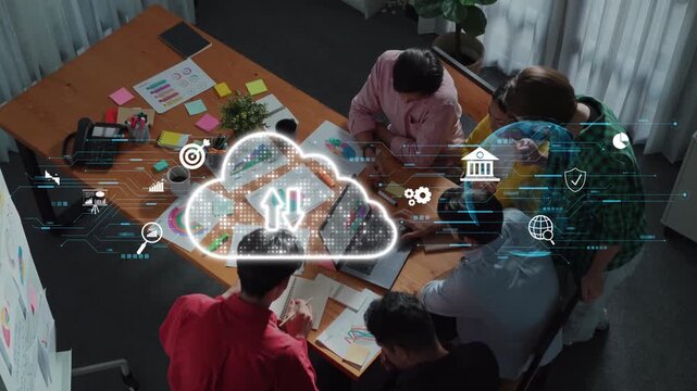 A diverse team gathers around a table for a brainstorming session, utilizing cloud technology and digital tools for innovative project planning and enhancing teamwork. Raster