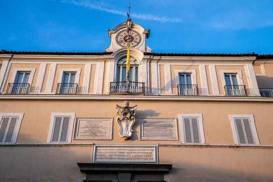Facade of the Apostolic Palace with clock and papal inscriptions in Castel Gandolfo, Italy