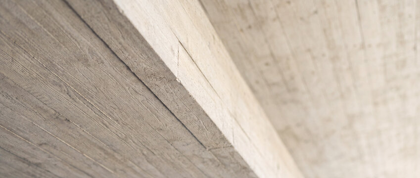 Concrete beam ceiling close-up with textured formwork lines in modern industrial architecture