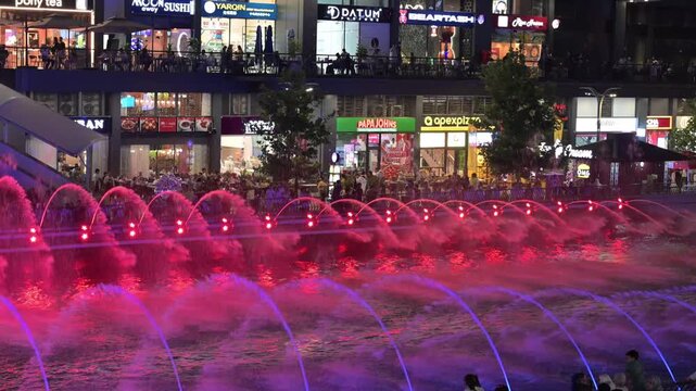 Tashkent, Uzbekistan - June 08, 2026: Seoul Mun Street.  Colorful fountain show with spectators enjoying evening performance.