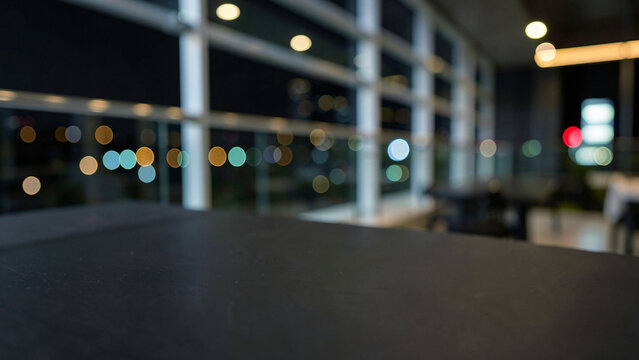 Matte Black Slate Table Surface on Modern Penthouse Balcony Bar with Glass Railings Luxury City Boke