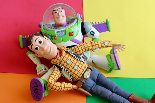 Salvador, Brazil - June 15, 2026: Sheriff Woody and Buzz Lightyear toys on a colorful background. Toy Story movie concept.