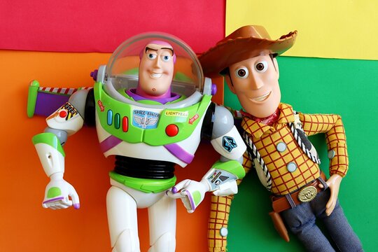 Salvador, Brazil - June 15, 2026: Sheriff Woody and Buzz Lightyear toys on a colorful background. Toy Story movie concept.