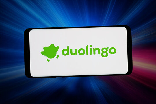 Stuttgart, Germany - 06-10-2026: In this photo illustration, the logo of educational technology company Duolingo Inc. is displayed on a smartphone in front of abstract background on computer screen.