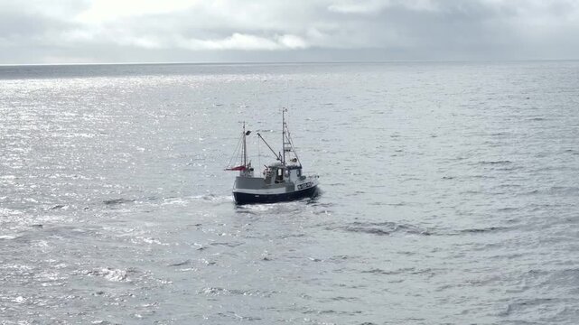 Small fishing boat on calm open sea