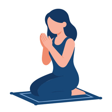 Young woman kneeling on a prayer mat with hands clasped in prayer or meditation