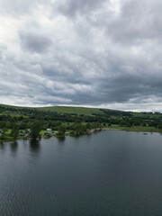 Obraz premium Aerial View of Lake Districts Valley and Mountains of UK. Drone Camera View Was Captured From Medium High Altitude During Mostly Dramatic Cloudy Day of Summer 2026