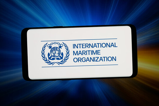 Stuttgart, Germany - 06-10-2026: In this photo illustration, the logo of International Maritime Organization (IMO) is displayed on a smartphone in front of abstract background on computer screen.