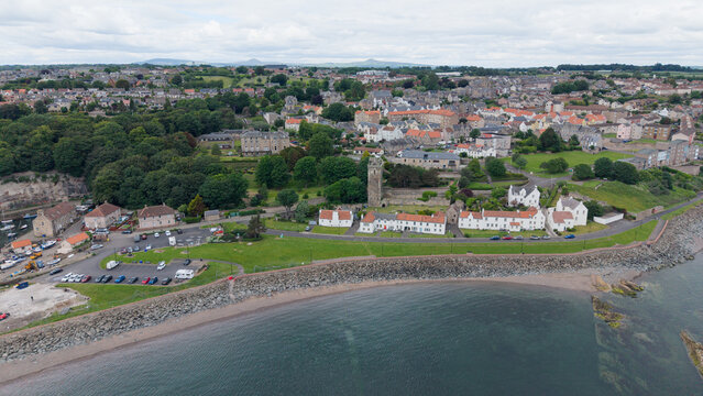 Scenic aerial view of Dysart historic village with traditional architecture, shoreline of the Firth of Forth, and St Serf's Tower in Fife, Scotland.