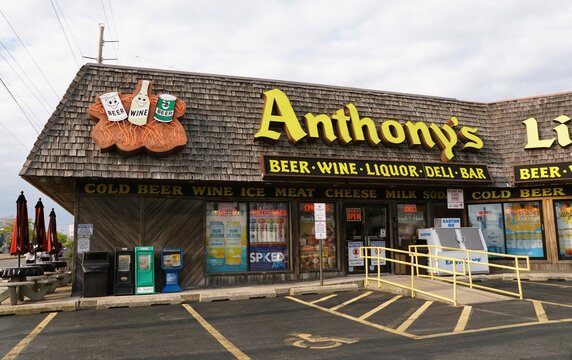 Ocean City, Maryland, U.S.A - June 10, 2026 - Anthony's Liquor store features bold signage, cartoon beverage icons, product ads, and outdoor vending boxes.