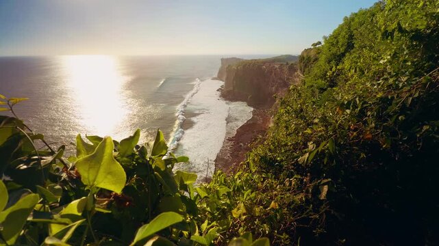 Slow Motion Coastal Panorama Of Karang Boma Cliff With Sunlight Reflecting Across Ocean Waves, Nature Travel And Exploration