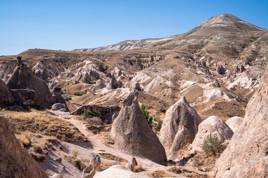 Hilly and desert landscape in the Devrent Valley in Cappadocia on a summer day.