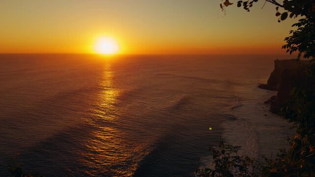 Timelapse Sunset Over Karang Boma Cliff And Endless Ocean With Golden Reflection Across Water, Coastal Serenity And Natural Beauty