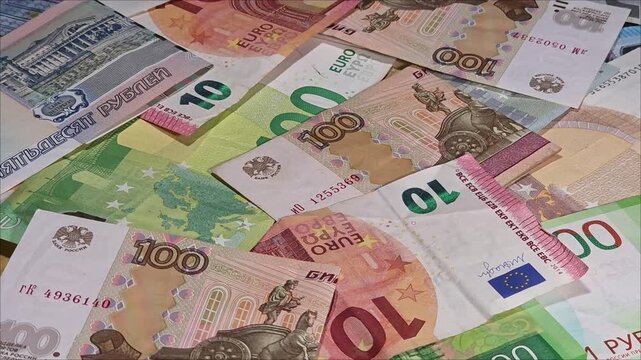 Panning shot of collage with euro and Russian ruble banknotes, economic crisis