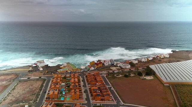 Wide approach to coastal town Galdar and crashing waves, Gran Canaria