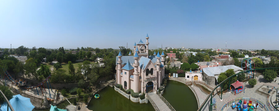 A 180-degree aerial wide-angle panorama of an amusement park.