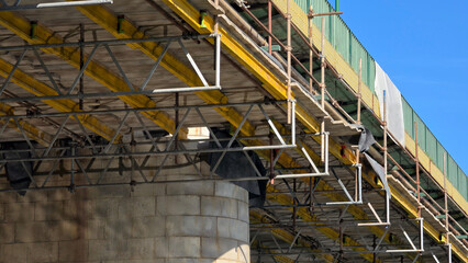 Steel scaffolding framework built under a concrete bridge deck for restoration works