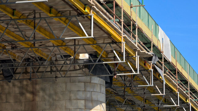 Steel scaffolding framework built under a concrete bridge deck for restoration works