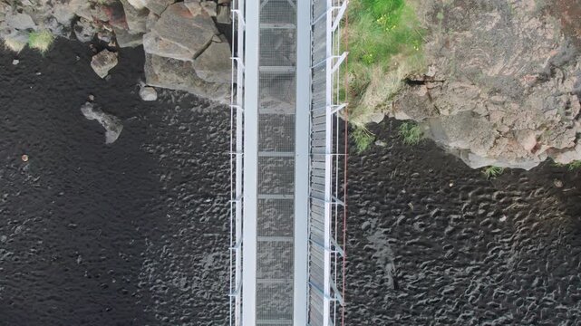 Aerial drone footage flying over the Bridge Between Continents, a symbolic footbridge over a major fissure separating two tectonic plates