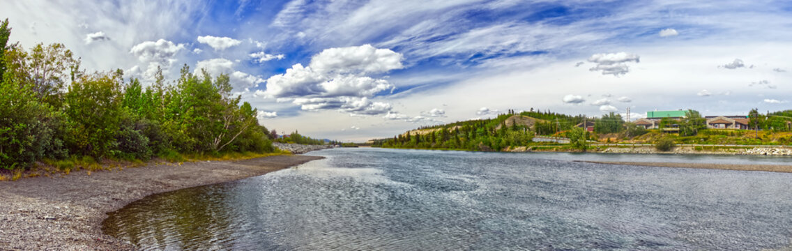 Beautiful clouds hang in the horizon over the Yukon river in Whitehorse, YT, Canada