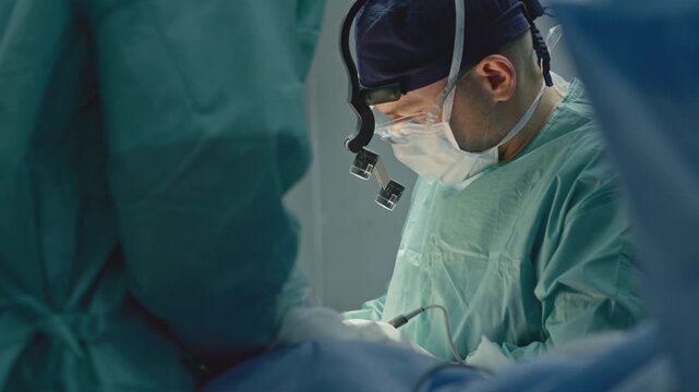 Two medics in operation room working together skilled doctor man surgeon physician medic work busy with operation operating patient with nurse intern help cooperate at microsurgery innovative medicine